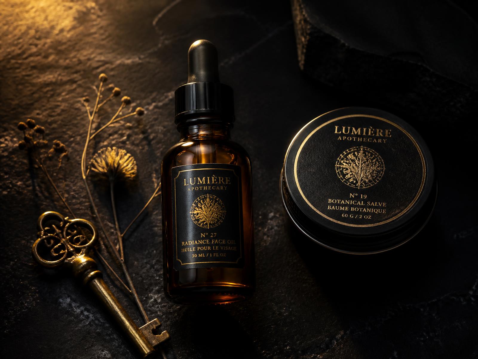 Amber apothecary bottle, black tin and antique brass key on dark stone